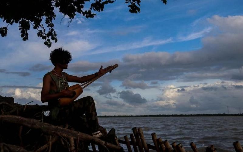 A baul sings by the river in an autumn afternoon in Kuchubunia, Batiaghata, Khulna on 27 August. Photo: Saddam Hossain