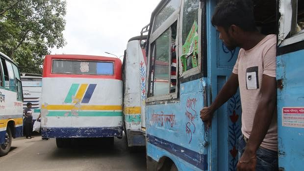 Two buses racing at Gulistan bus terminal in Dhaka on 10 September. The reckless competition is a common scene in the area. Photo: Abdus Salam