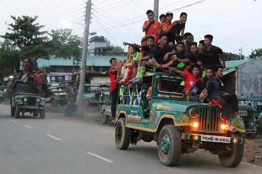 After a football match, a group of players and their supporters return riding a human hauler at Chengi Bridge, Khagrachhari on 8 September. Human haulers often fall in accidents in the area. Photo: Nerob Chowdhury