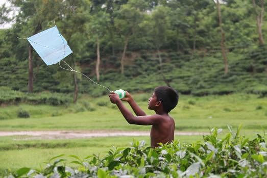 A child plays with a kite in Lakkatura tea garden of Sylhet on 9 September. Photo: Anis Mahmud