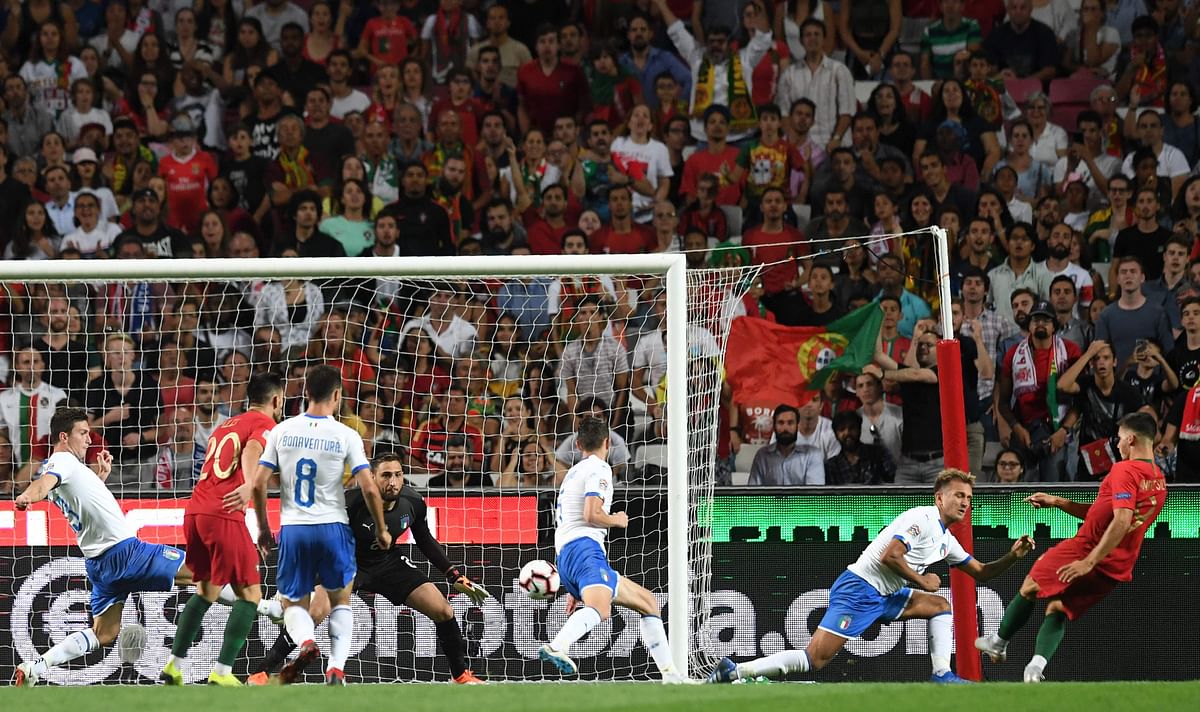 Portuguese forward Andre Silva (R) scores the winner against Italy during the UEFA Nations League football match at the Luz stadium in Lisbon on September 10, 2018. AFP
