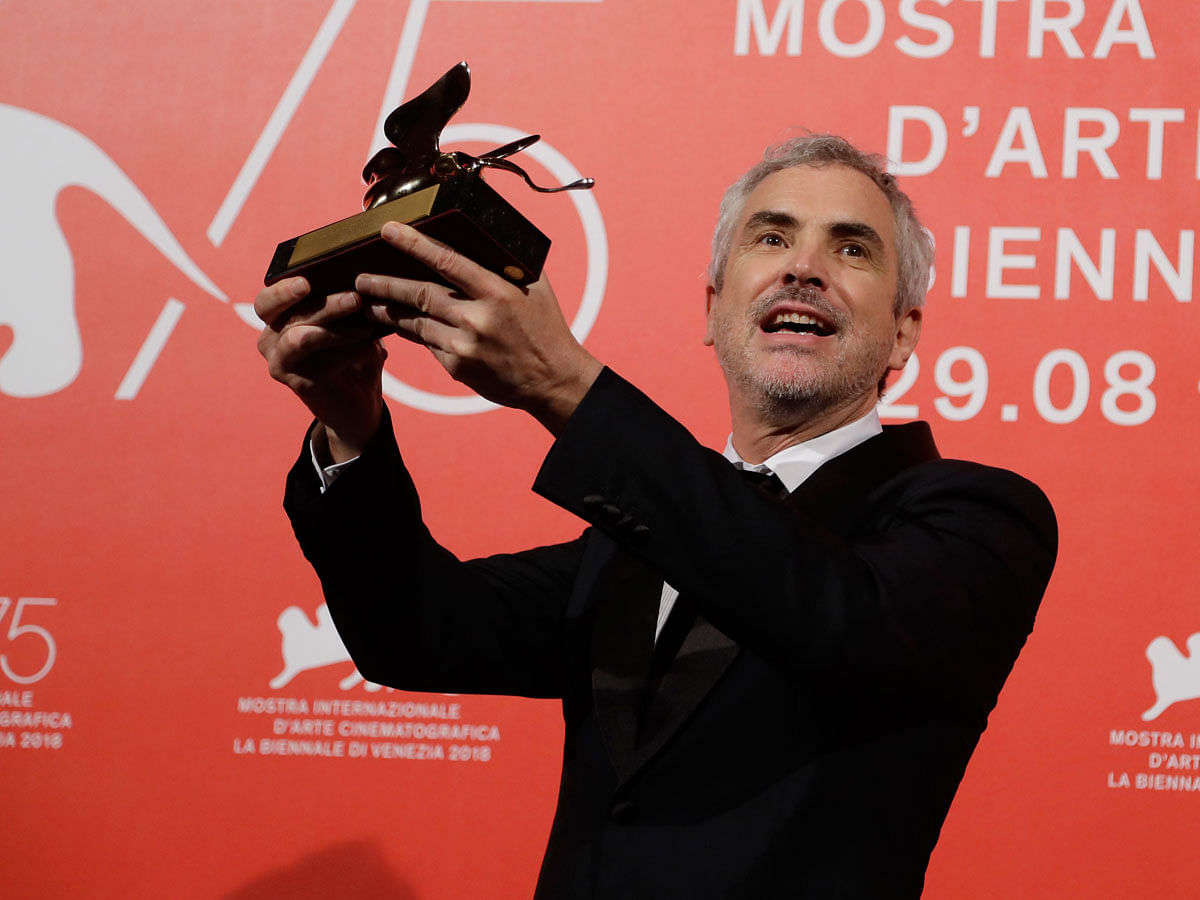 Director Alfonso Cuaron holds aloft the Golden Lion Best Film award for `Roma` at the awards photo call of the 75th edition of the Venice Film Festival in Venice, Italy, on 8 September 2018. Photo: AP
