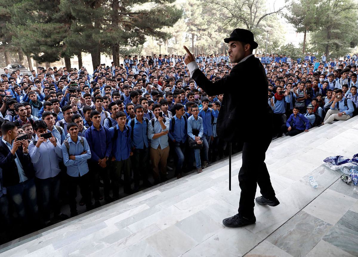 Afghanistan`s Charlie Chaplin, Karim Asir, 25, performs at a school in Kabul, Afghanistan on 5 September, 2018. Photo: Reuters