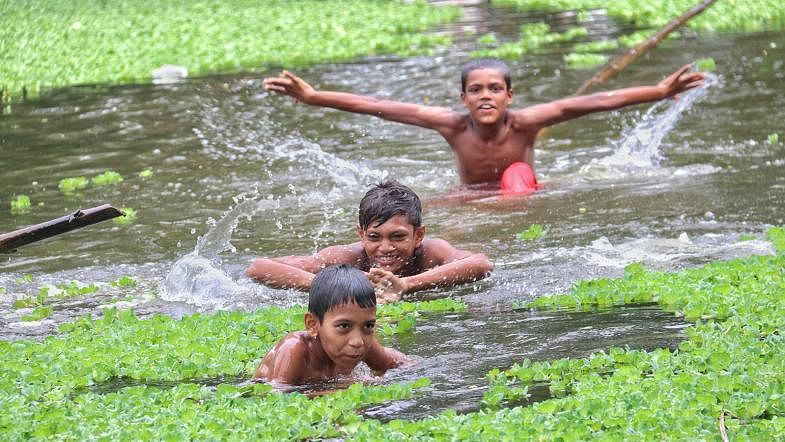 Boys having fun in the water in a hot afternoon in Baniakhali, Dumuria, Khulna on 12 September. Photo: Saddam Hossain
