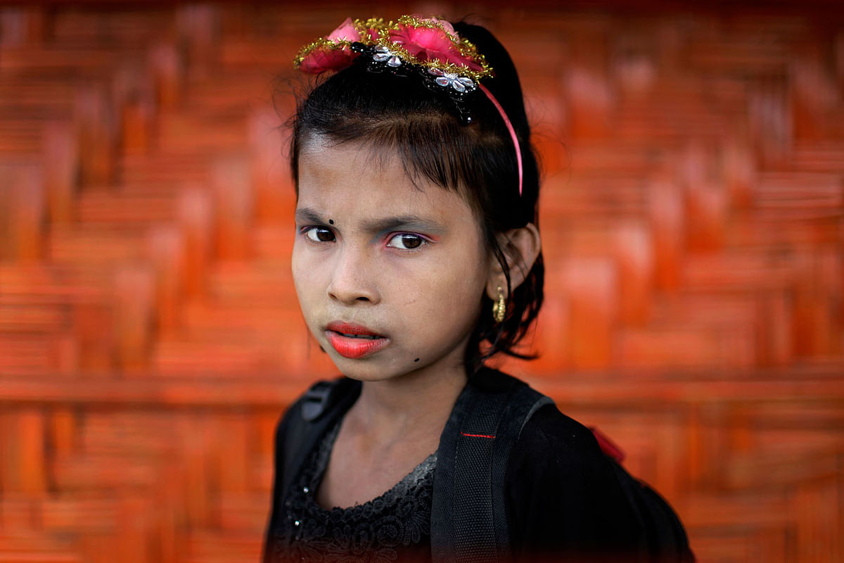 In this 27 June 2018, photo, Ranjeda, 9, poses for a portrait in front of her classroom in Chakmarkul refugee camp, Bangladesh. Photo: AP