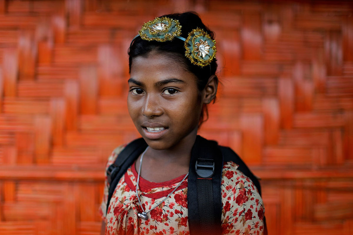 In this 27 June 2018, photo, Zesmin, 10, poses for a portrait in front of her classroom in Chakmarkul refugee camp, Bangladesh. Photo: AP