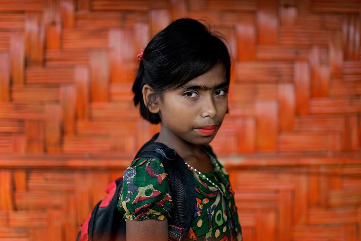 In this 27 June 2018, photo, Taslima, 10, poses for a portrait in front of her classroom in Chakmarkul refugee camp, Bangladesh. Photo: AP
