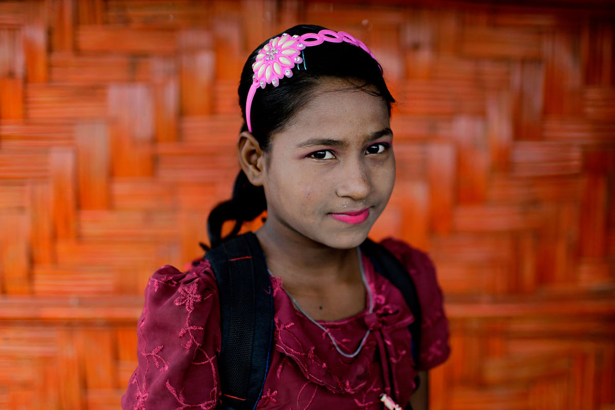 In this 27 June 2018, photo, Shamshoda, 10, poses for a portrait in front of her classroom in Chakmarkul refugee camp, Bangladesh. Photo: AP