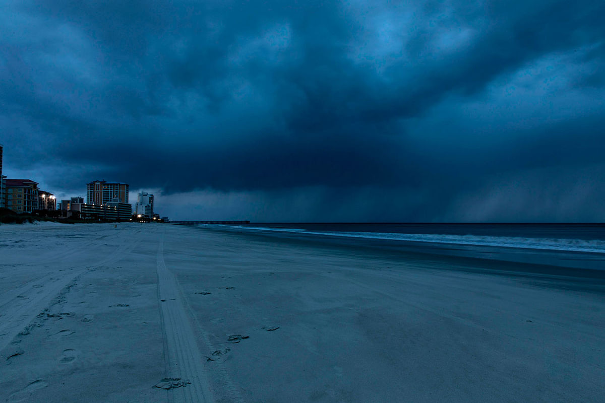 Rain begins to fall as the outer bands of Hurricane Florence make landfall in Myrtle Beach, South Carolina on 13 September. Photo: AFP