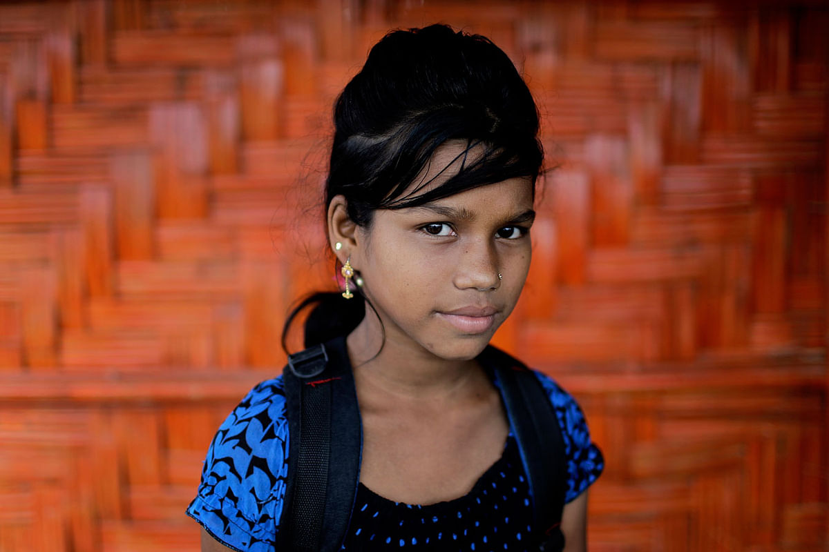 In this 27 June 2018, photo, Astafa, 10, poses for a portrait in front of her classroom in Chakmarkul refugee camp, Bangladesh. Photo: AP