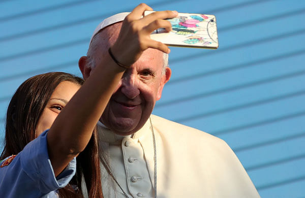 Pope Francis takes a selfie with a faithful as he meets with young people at the Politeama Square in Palermo, Italy on 15 September. Photo: Reuters