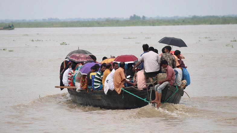 People ride a boat over Padma river taking risks in a hostile weather. Alimuzzaman took the photo from Dhalar Mor area of Faridpur on 13 September.