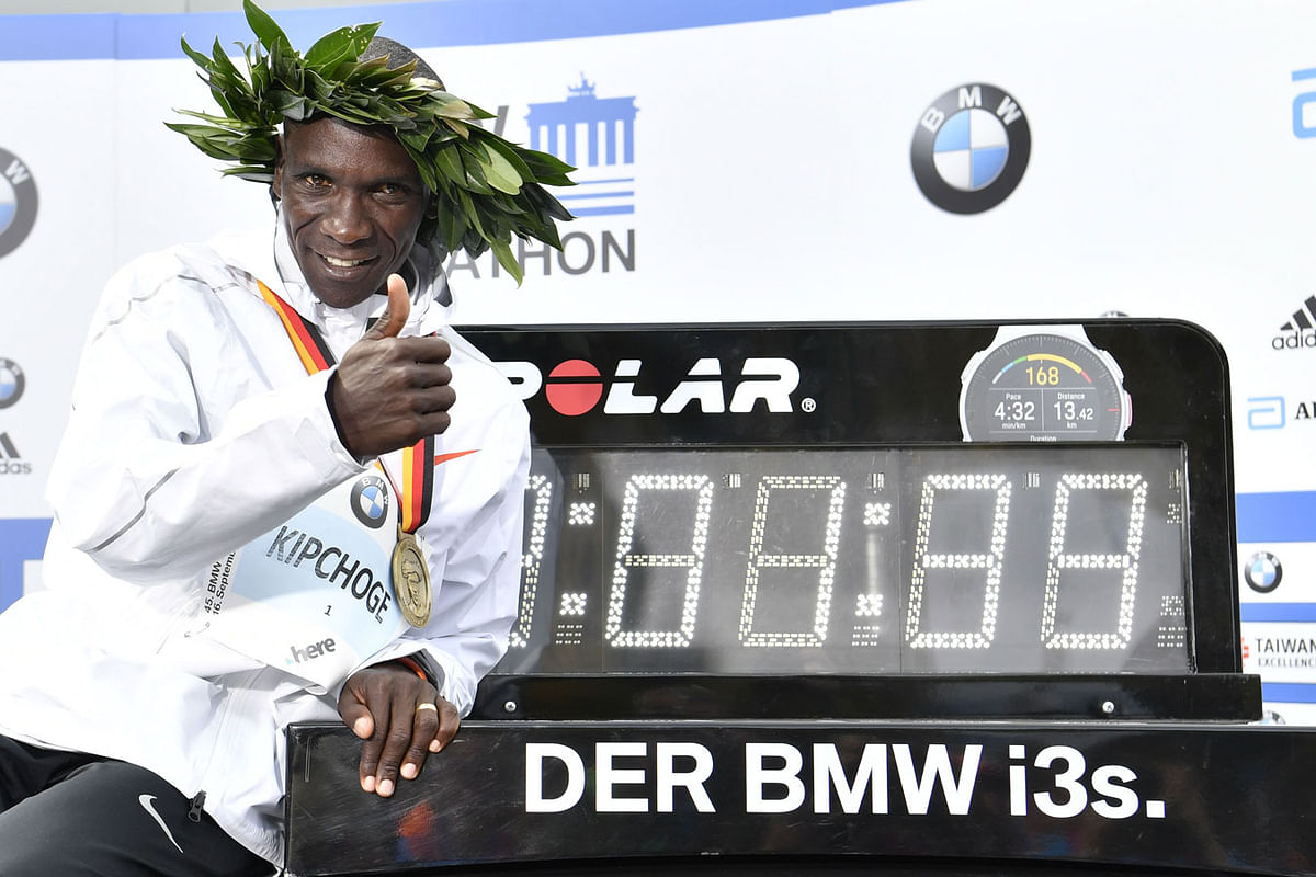 Winner Kenya`s Eliud Kipchoge poses with a clock displaying his time after winning the Berlin Marathon setting a new record on 16 September 2018 in Berlin. Photo: AFP