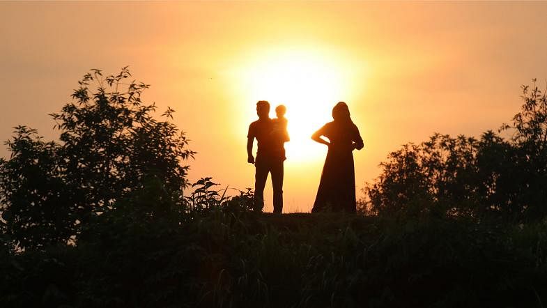 Members of a family watch sunset at Circuit House area of Khagrachhari on 13 September. Photo: Nerob Chowdhury