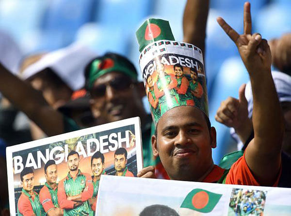 An ecstatic Bangladeshi fan shows the victory sign.
