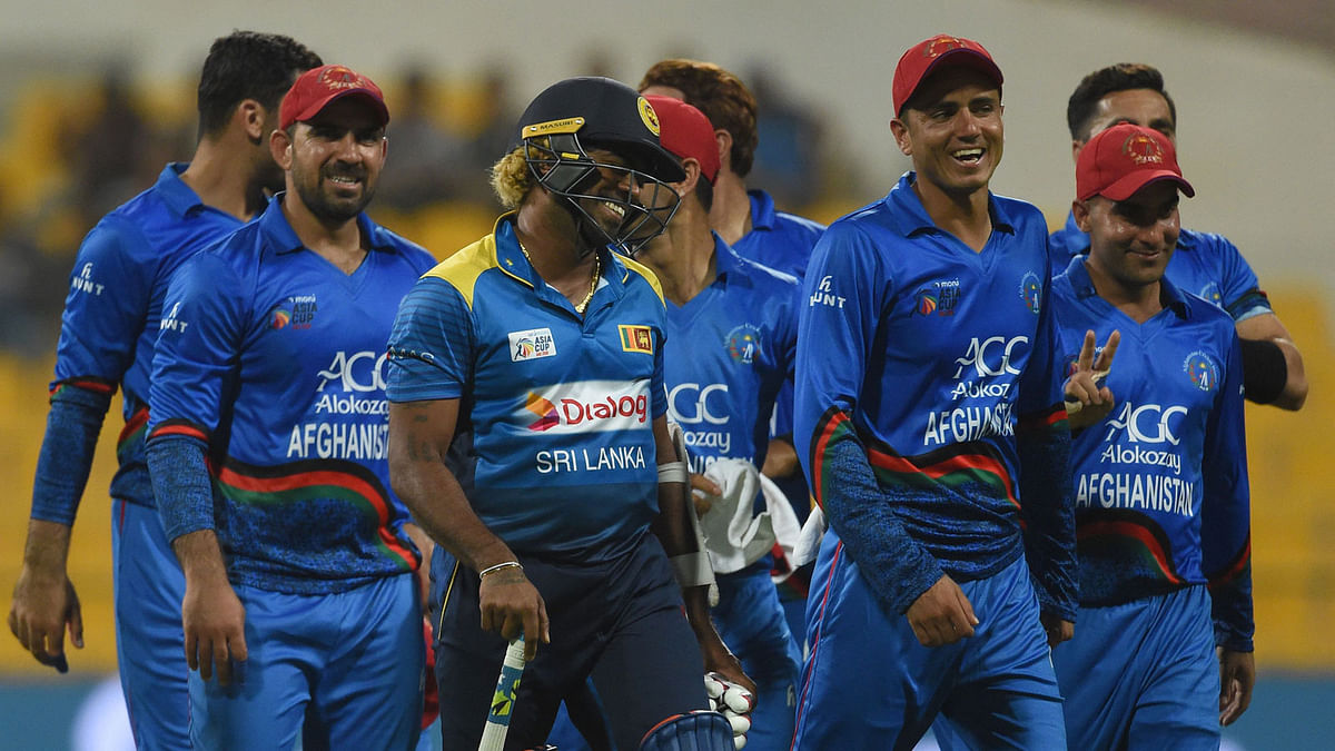 Afghan cricketer Mujeeb Ur Rahman (2R) shares a light moment with Sri Lanka`s Lasith Malinga (3L)as they leave the field at the end of the one day international (ODI) Asia Cup cricket match between Sri Lanka and Afghanistan at the Sheikh Zayed Stadium in Abu Dhabi on 17 September, 2018. Photo: AFP