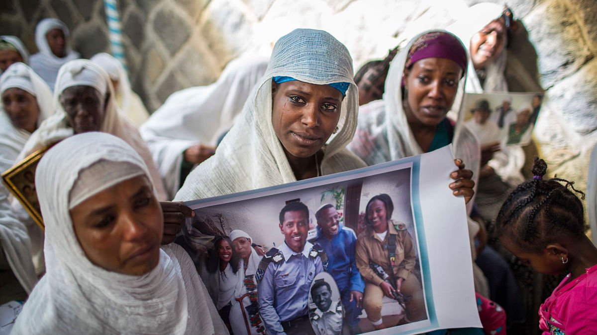 In this 28 February 2018 file photo, members of Ethiopia`s Jewish community hold pictures of their relatives in Israel, during a solidarity event at the synagogue in Addis Ababa, Ethiopia. Photo: AP