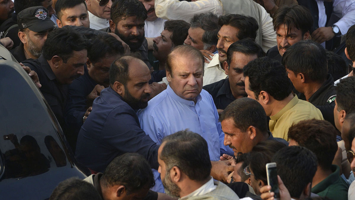In this file photo taken on 14 September 2018 former Pakistani prime minister Nawaz Sharif (C) arrives to attend the funeral prayer of his late wife Kulsoom Nawaz in Lahore. AFP