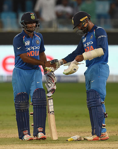 Indian batsmen Dinesh Karthik (R) and Ambati Rayudu greet each other after their teams` victory in the one day international (ODI) Asia Cup cricket match between Pakistan and India at The Dubai International Cricket Stadium in Dubai on 19 September, 2018. Photo: AFP