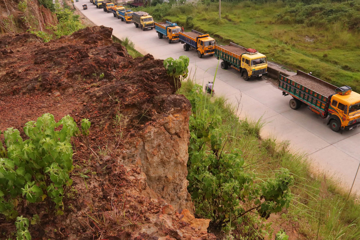 Vehicles ply by a road beside cracked hills in Barashala area of Sylhet on 19 September. The hills due to landslides have caused accidents several times before. Photo: Anis Mahmud