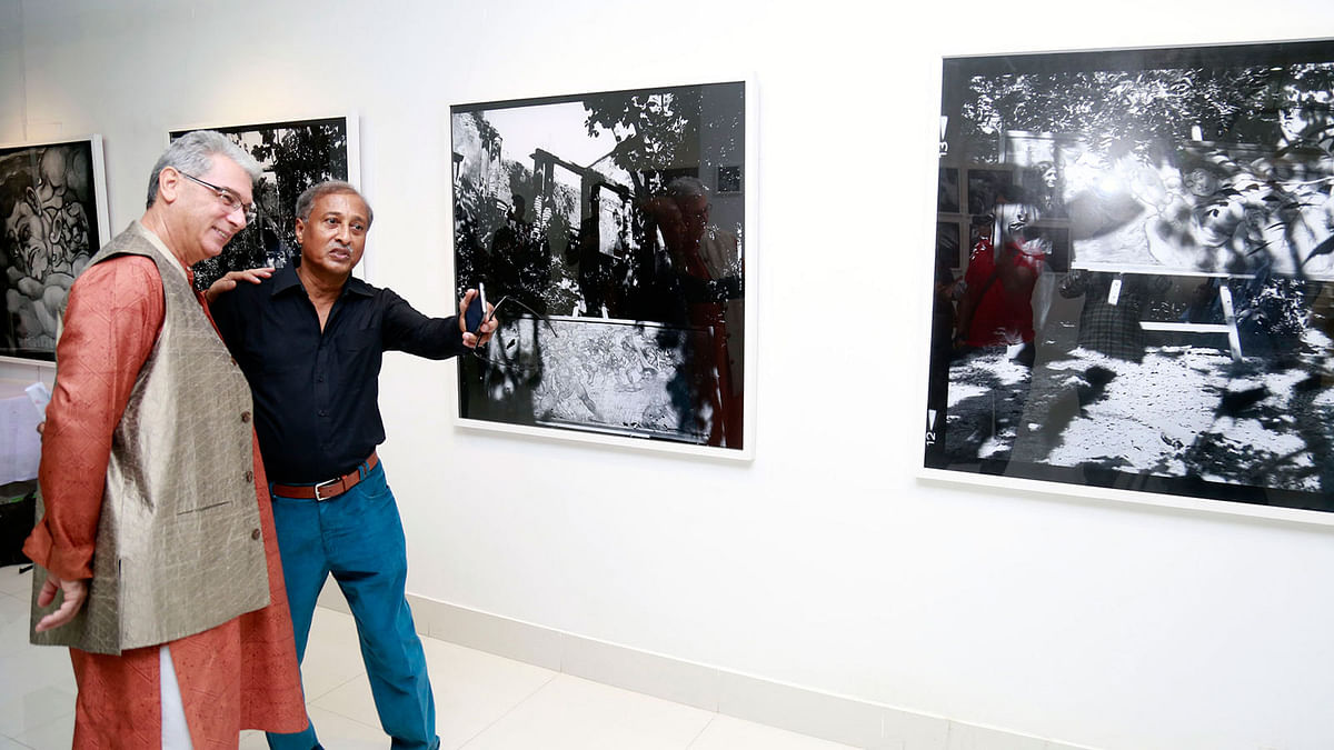 Portrait photographer Nasir Ali Mamun briefs photographs to a visitor on Thursday. Photo: Prothom Alo