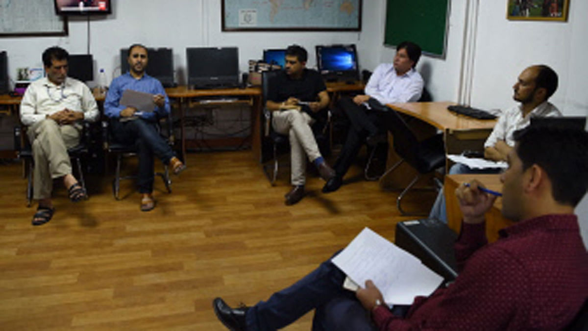 In this photograph taken on 11 September 2018 Afghan reporters at Tolo News take part in an editorial meeting at Tolo TV station in Kabul. Moments after Afghan journalist Samim Faramarz wrapped up his live report on the latest suicide attack in Kabul, a car bomb exploded just metres away, killing him and his cameraman Ramiz Ahmadi. Their colleagues at Tolo News choked back tears as they reported the deaths live on air—cracking open a divisive debate on how Afghan journalists should operate in such a dangerous environment. Photo: AFP