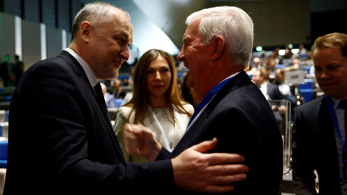 Craig Reedie, president of the World Anti Doping Agency (WADA) (2R) welcomes Yuri Ganus, Russian Anti-Doping Agency (RUSADA) director general at the WADA Symposium in Ecublens, near Lausanne, Switzerland, on 21 March 2018. Reuters File Photo