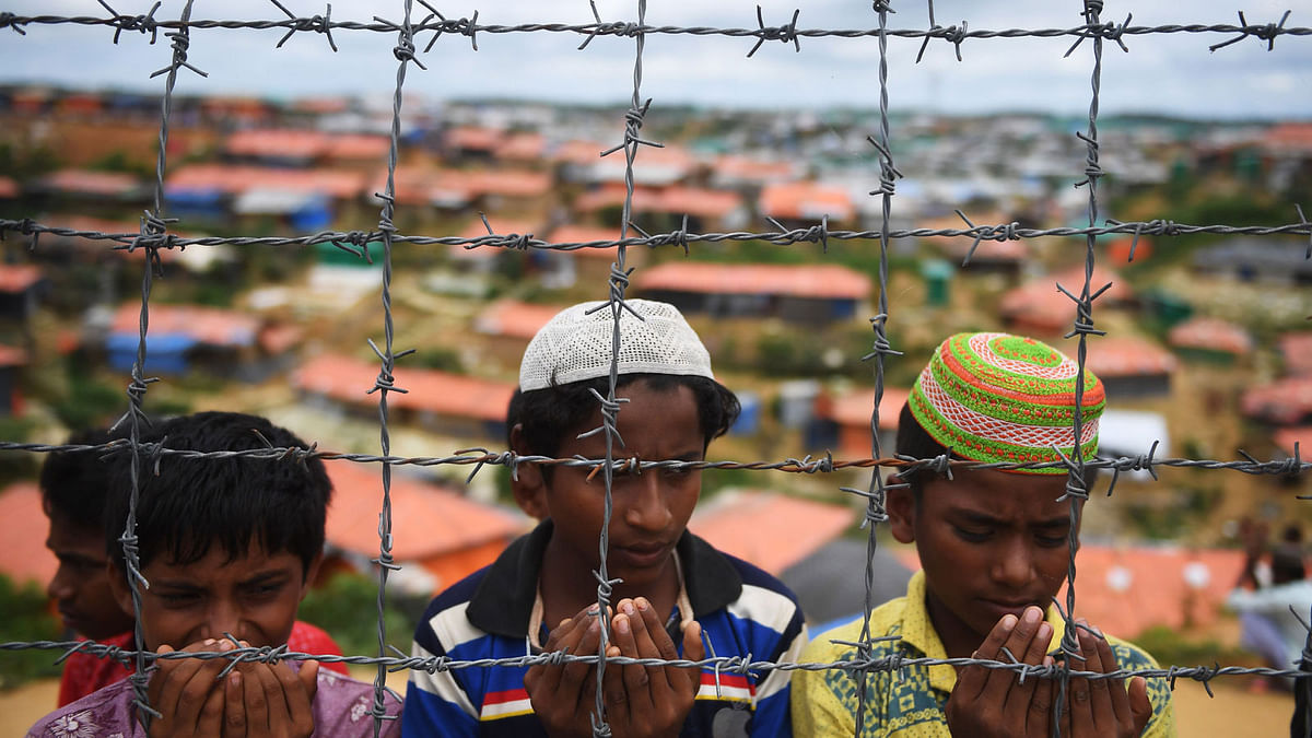 In this file photo taken on 25 August 2018 Rohingya refugees perform prayers as they attend a ceremony organised to remember the first anniversary of a military crackdown that prompted a massive exodus of people from Myanmar to Bangladesh, at the Kutupalong refugee camp in Ukhia. Photo: AFP