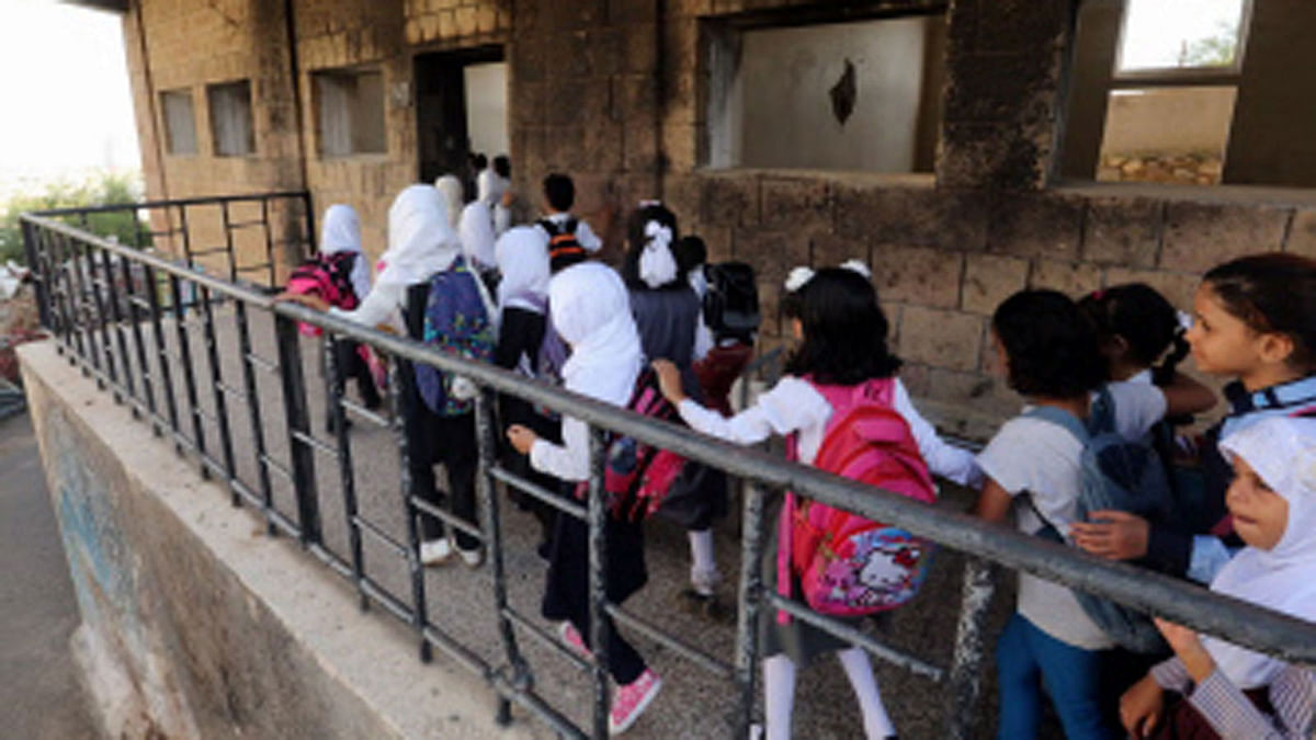 Yemeni students walk into their classroom on the first day of the new academic year on 16 September 2018, at a school that was damaged last year in an air strike during fighting between the Saudi-backed government forces and the pro-Iranian Huthi rebels in the country`s third-city of Taez. Since Riyadh and its allies intervened in Yemen in March 2015, around 10,000 people have been killed in a conflict which has sparked a grave humanitarian crisis. Photo: AFP
