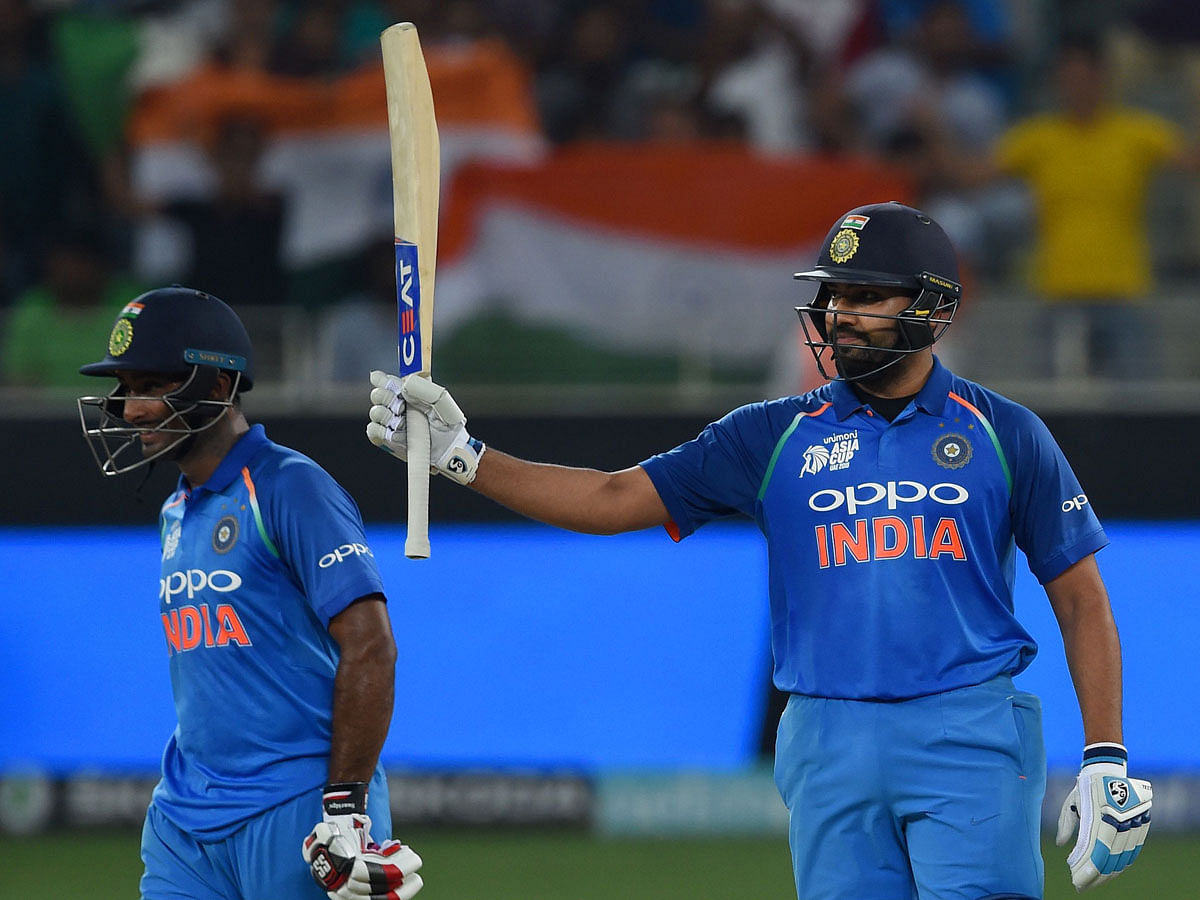 Indian Cricket team captain Rohit Sharma (R) celebrates after scoring a half-century (50 runs) as Ambati Rayudu (L) looks on during the one day international (ODI) Asia Cup cricket match between Bangladesh and India at the Dubai International Cricket Stadium in Dubai on September 21, 2018. AFP