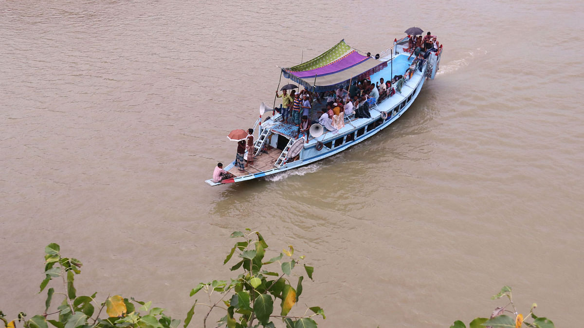 A boat carrying tourists across Surma river in Tuker Bazar, Sylhet on 20 September. The rivers and haors, full of water this time of the year, attract tourists. Photo: Anis Mahmud