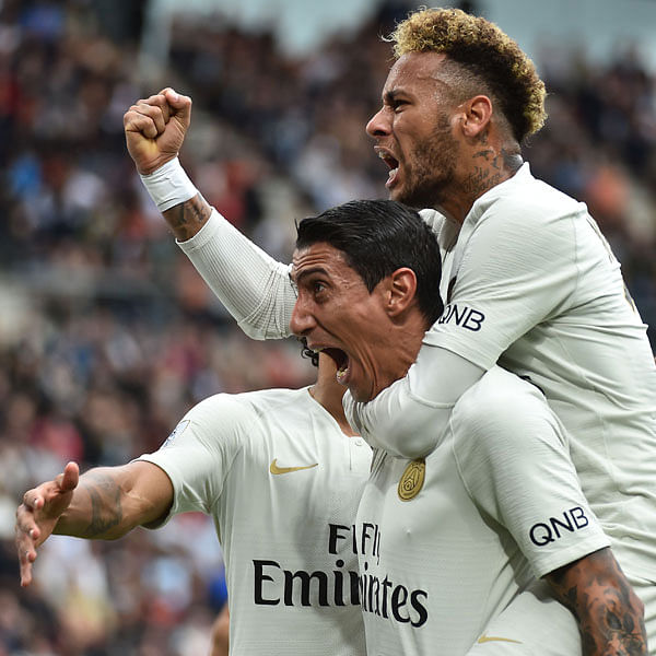 Paris Saint-Germain`s Argentine midfielder Angel Di Maria (bottom) celebrates with Paris Saint-Germain`s Brazilian forward Neymar after scoring the equalizer during the French L1 football match between Rennes and Paris Saint-Germain at the Roazhon Park stadium in Rennes, on 23 September 2018. Photo: AFP