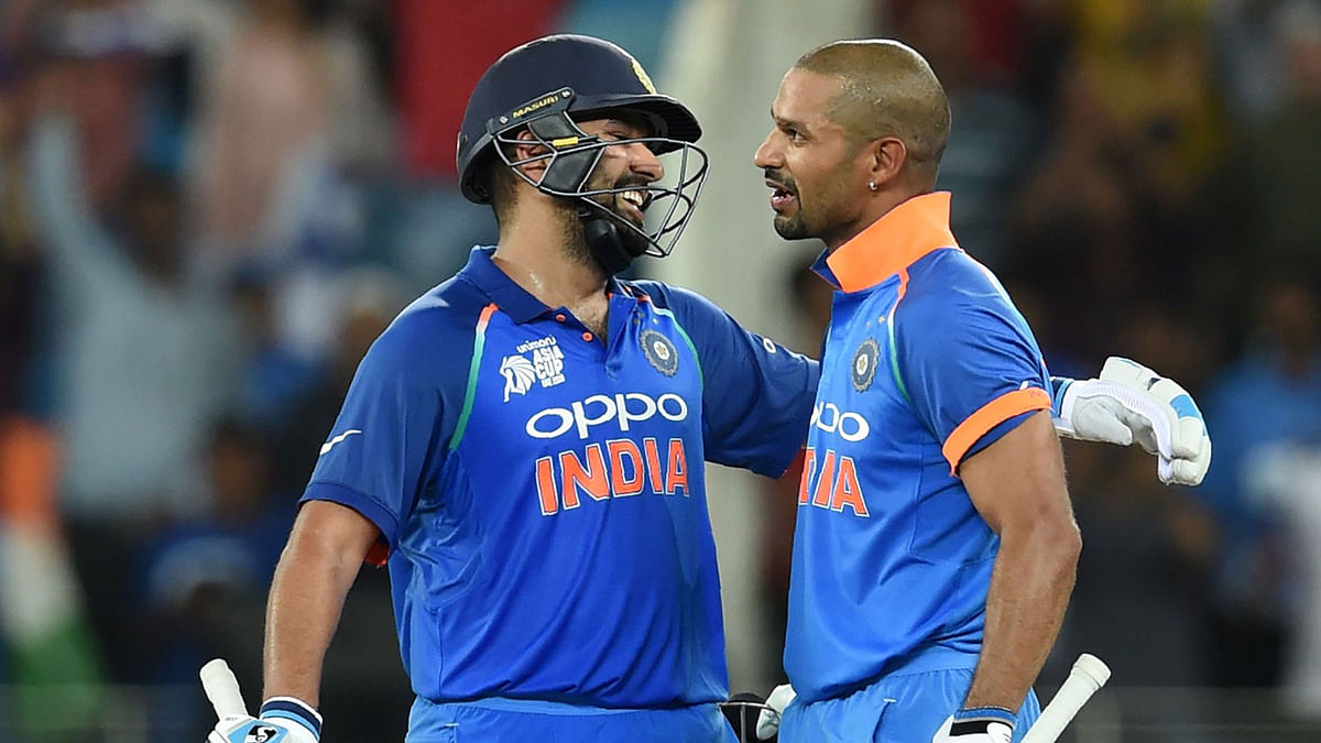 Indian cricket team captain Rohit Sharma (L) and his teammate Shikhar Dhawan greet each other during the one day international (ODI) Asia Cup cricket match between Pakistan and India at the Dubai International Cricket Stadium in Dubai on 23 September 2018. Photo:  AFP
