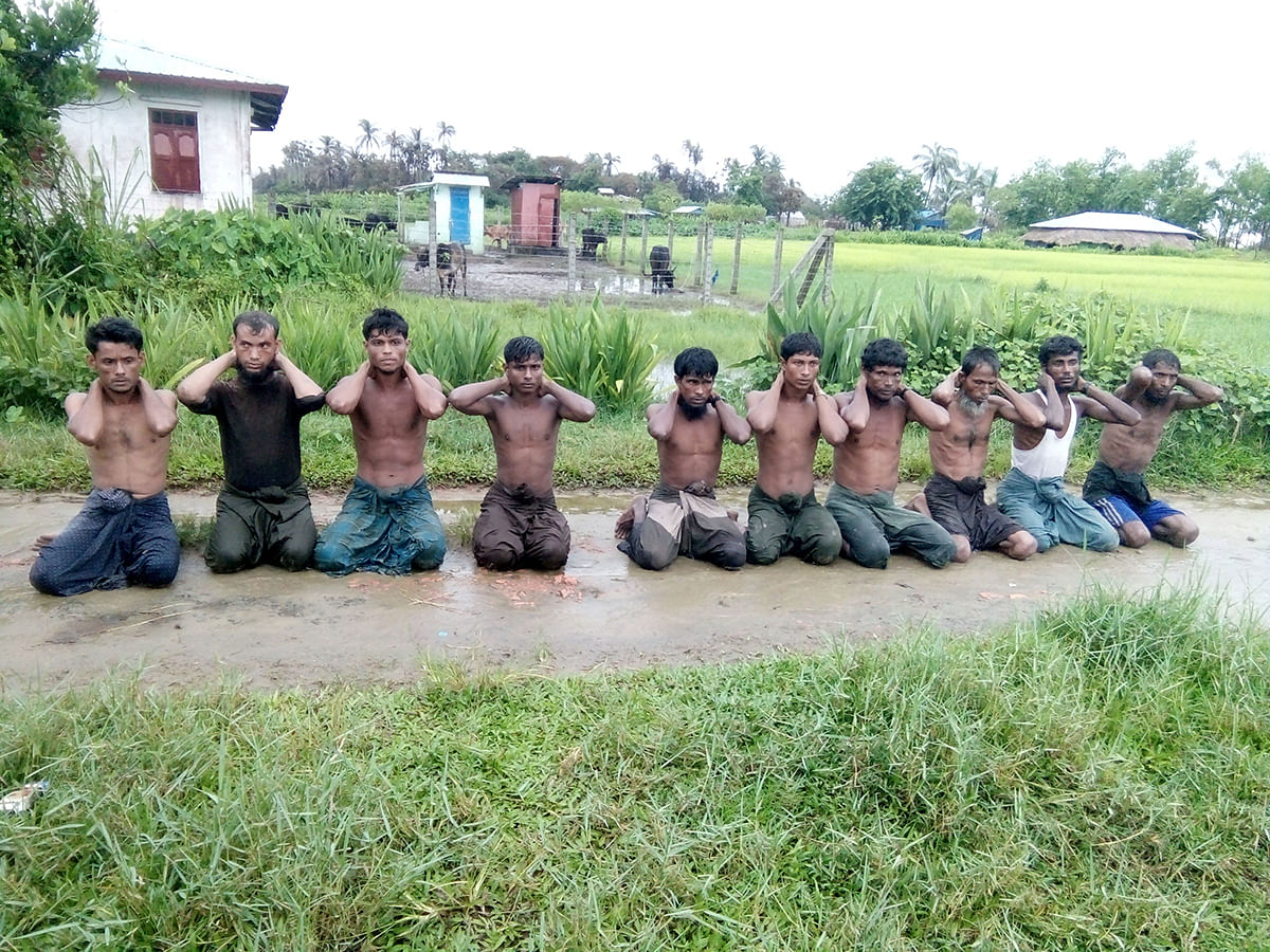 Ten Rohingya Muslim men with their hands bound kneel in Inn Din village on 1 September, 2017. Photo: Reuters