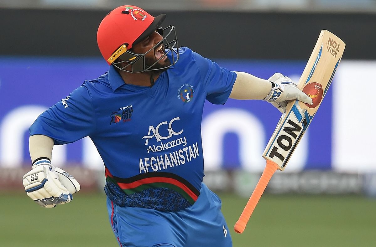Afghan batsman Mohammad Shahzad celebrates after scoring a century (100 runs) during the one day international (ODI) Asia Cup cricket match against India at the Dubai International Cricket Stadium in Dubai on 25 September 2018. Photo: AFP