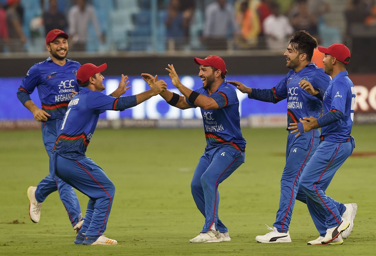Afghan cricketer Rashid Khan (2R) celebrates with teammate after match tie during the one day international (ODI) Asia Cup cricket match between Afghanistan and India at the Dubai International Cricket Stadium in Dubai on 25 September 2018. AFP