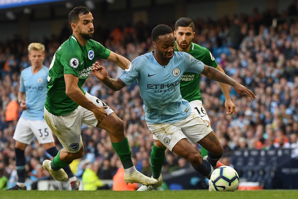 Manchester City`s English midfielder Raheem Sterling (R) vies with Brighton`s Spanish defender Martin Montoya during the English Premier League football match between Manchester City and Brighton and Hove Albion at the Etihad Stadium in Manchester, north west England, on 29 September. Photo: AFP