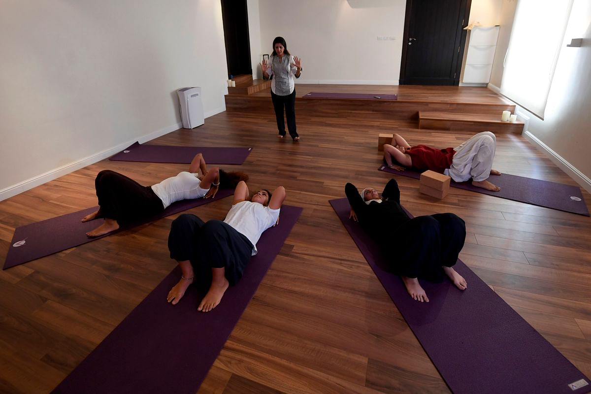 Nouf Marwaai, 38, the head of the Arab Yoga Foundation (background) instructs a yoga class at her studio in the western Saudi Arabian city of Jeddah on 7 September 2018. Photo: AFP