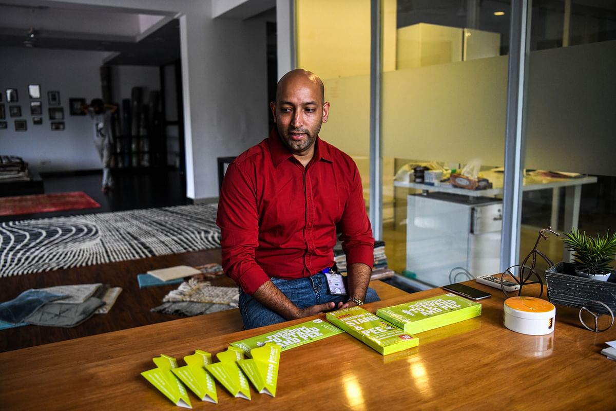 In this photograph taken on 21 September 2018 founder of `Pee Buddy` Deep Bajaj looks on as he shows portable female urination devices inside the company`s office in New Delhi. Photo: AFP