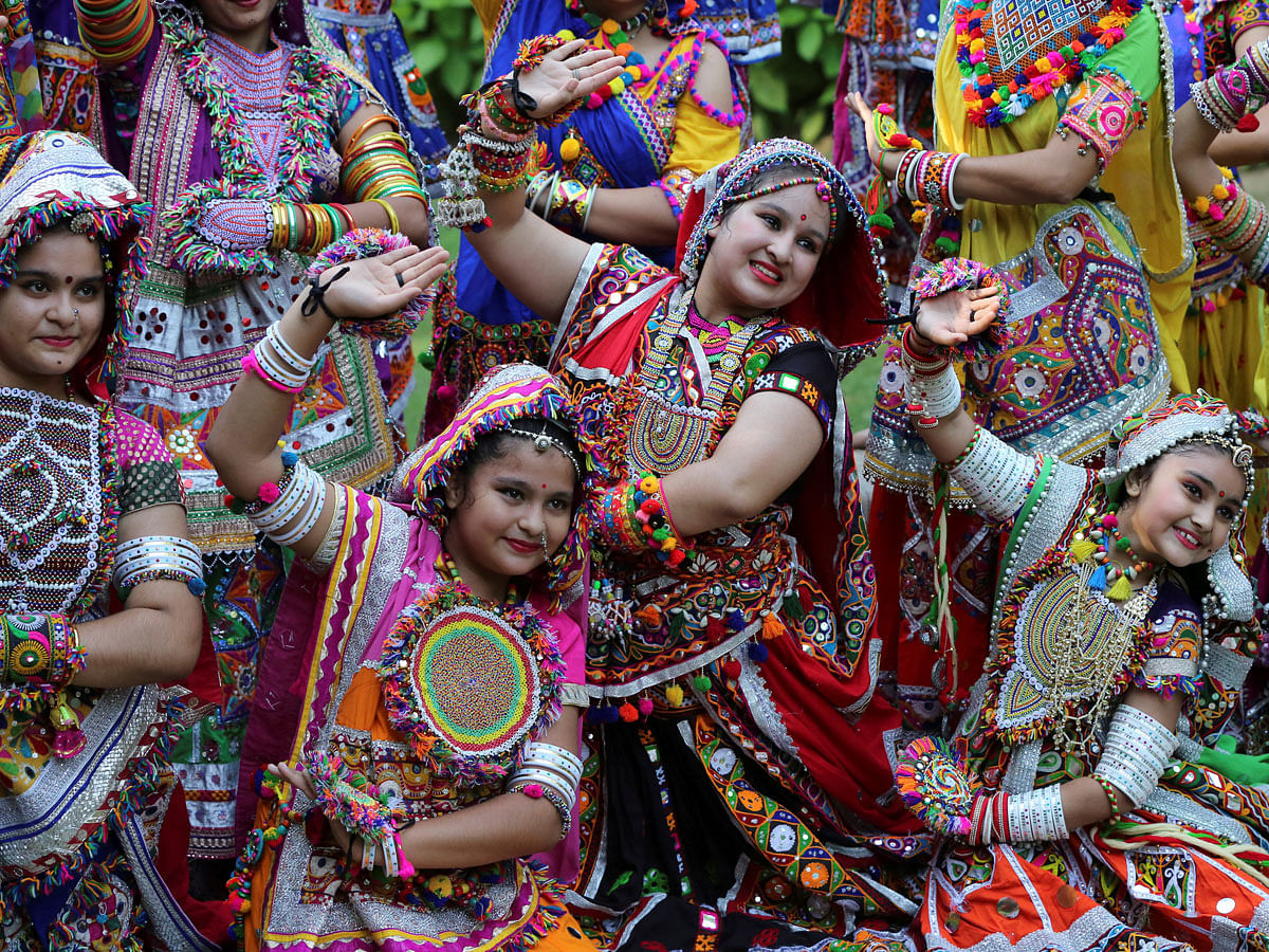 Participants dressed in traditional attire pose during rehearsals for Garba, a folk dance, ahead of Navratri, a festival during which devotees worship the Hindu goddess Durga and youths dance in traditional costumes, in Ahmedabad, India on 30 September. Photo: Reuters