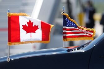 In this file photo taken on 8 June 2018 a limousine drives with US and Canadian flags before the arrival of US president at Canadian Forces Base Bagotville in Bagotville, Quebec, for G7 summit. Photo: AFP