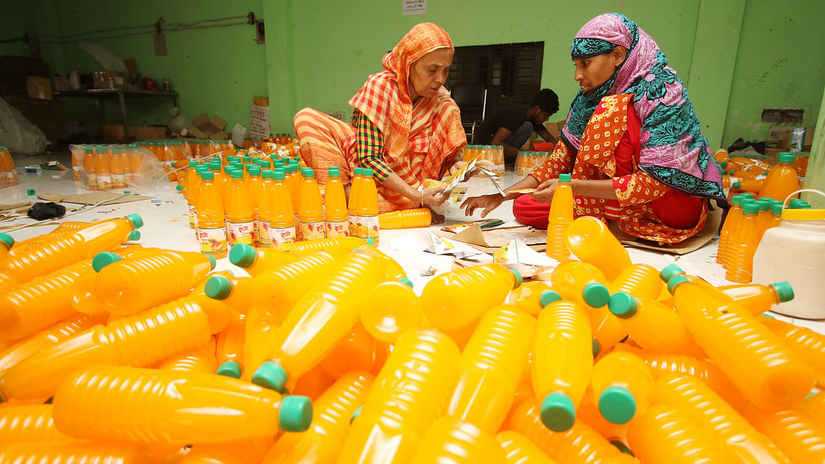 Workers at an illegal factory at Dakshin Sanarpar, Siddhirganj Narayanganj on 1 October. RAB-10 and BSTI conducted a drive in the factory where fake juice and other food items were seized. Photo: Abdus Salam