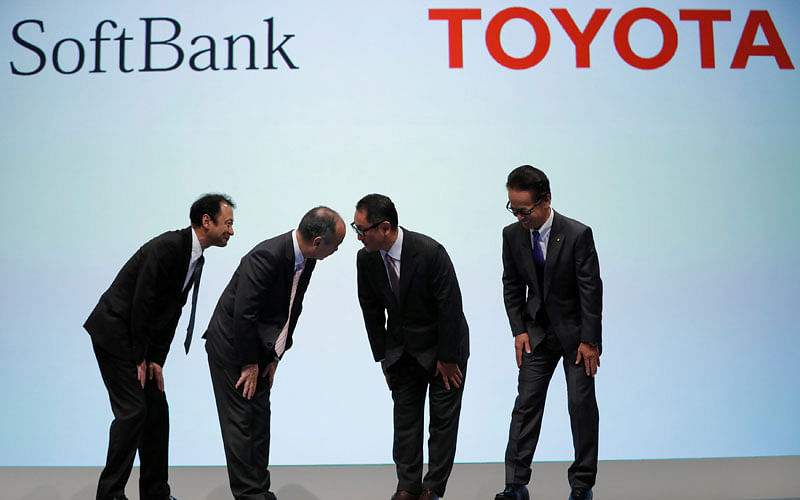 Toyota Motor Corp president Akio Toyoda and executive vice president Shigeki Tomoyama bow with SoftBank Group Corp chairman and CEO Masayoshi Son and SoftBank Corp representative director and CTO Junichi Miyakawa during their joint news conference in Tokyo, Japan on 4 October 2018. Photo: Reuters