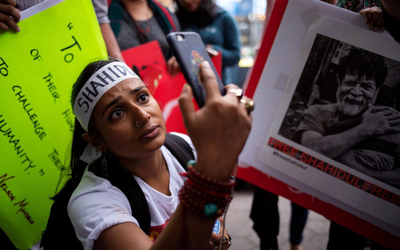 A woman takes pictures as journalists and activists protest against the arrest of Bangladeshi photojournalist Shahidul Alam, as Bangladeshi prime minister Sheikh Hasina attends the General Assembly of the United Nations in Manhattan, New York, US on 27 September. Photo: Reuters