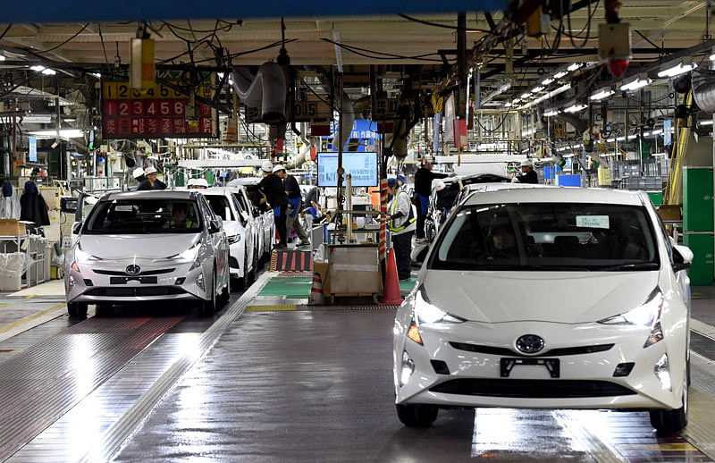 This file photo taken on 8 December 2017 shows fourth generation Toyota Prius cars being driven from the production line at the company`s Tsutsumi assembly plant in Toyota City, Aichi prefecture. Photo: AFP