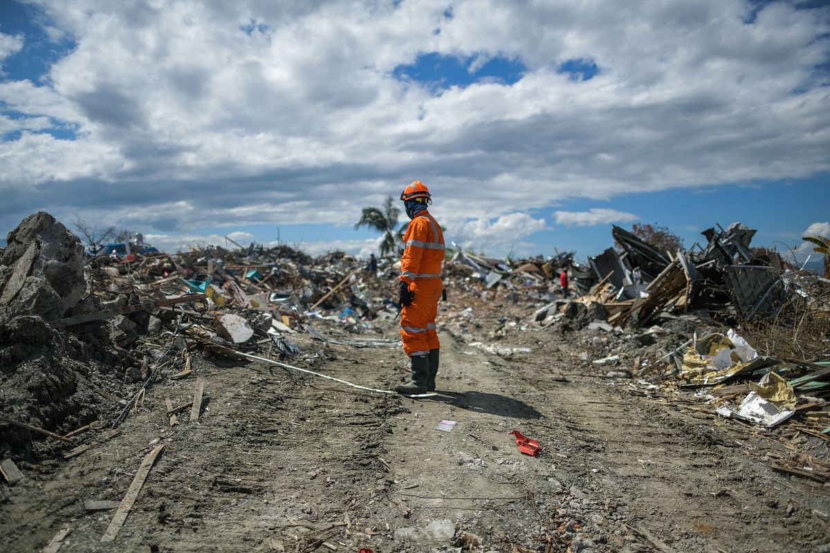 A member of an Indonesian search and rescue team looks at the debris in Petobo in Central Sulawesi on 8 October, 2018, following the 28 September earthquake and tsunami. Photo: AFP