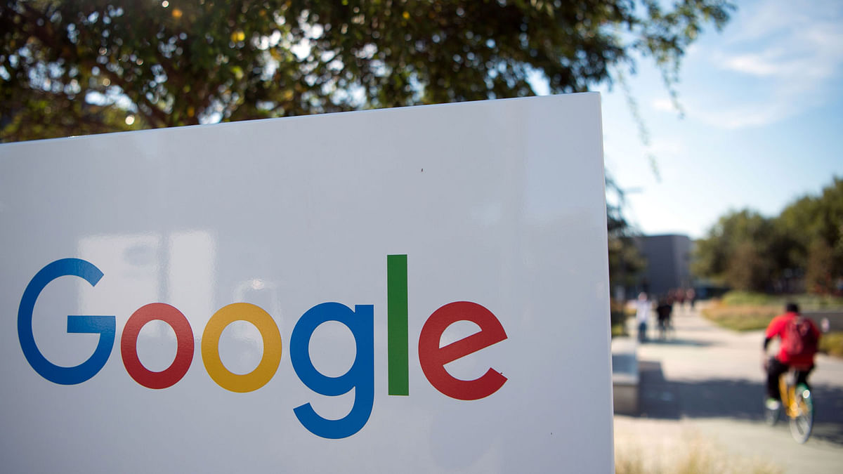 In this file photo taken on 4 November 2016 a man rides a bike pass a Google sign and logo at the Googleplex in Menlo Park, California. Google on 8 October 2018 announced it is shutting down the consumer version of its online social network after fixing a bug exposing private data in as many as 500,000 accounts. Photo: AFP