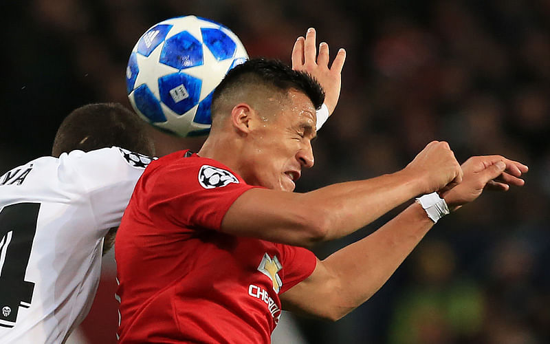 In this file photo taken on 2 October 2018 Manchester United`s Chilean striker Alexis Sanchez (R) headers the ball as he vies in the air with Valencia`s Spanish defender Jose Luis Gaya Pena during the Champions League group H football match between Manchester United and Valencia at Old Trafford in Manchester, north west England. Photo: AFP