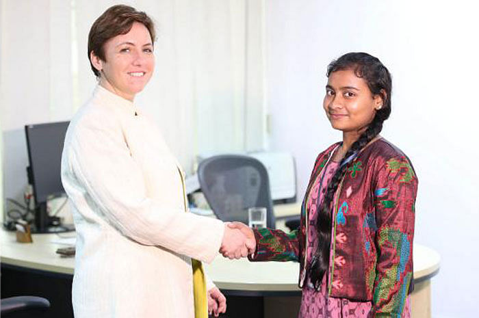 International Finance Corporation (IFC) country manager Wendy Werner (left) shakes hand with Bangladeshi girl Mahua Akhtar. Photo: Plan International