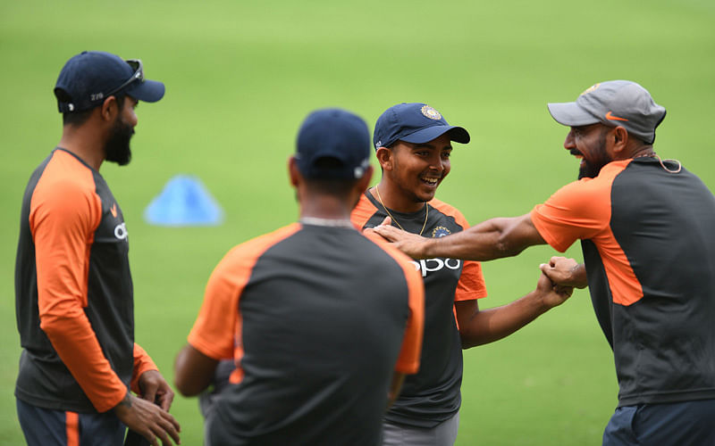 Indian cricketer Prithvi Shaw (2R) gesture with his teammates during a training session ahead of the second Test cricket match against West Indies at the Rajiv Gandhi International Cricket Stadium in Hyderabad on 10 October 2018. Photo: AFP